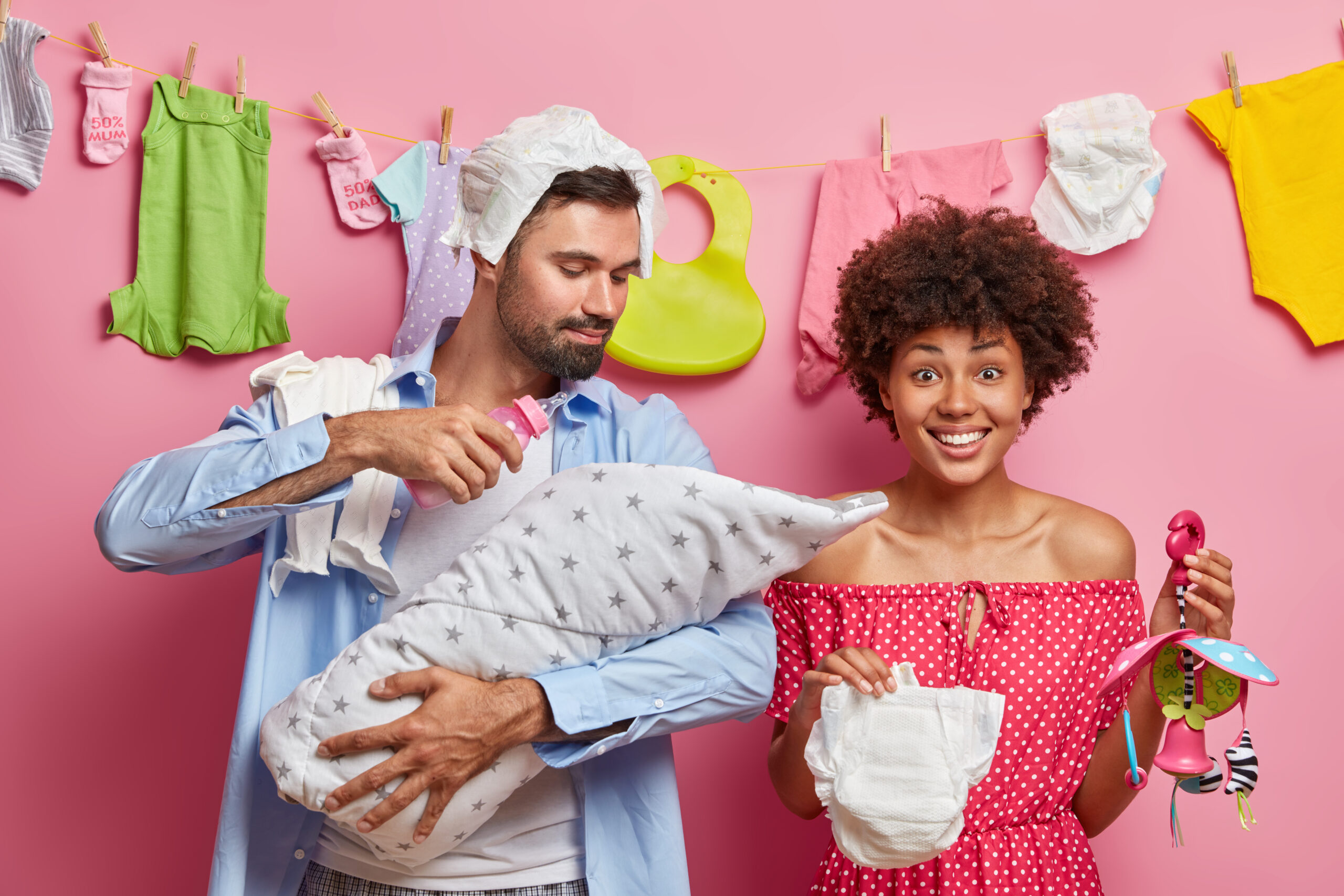 A happy couple preparing together for a new baby at home