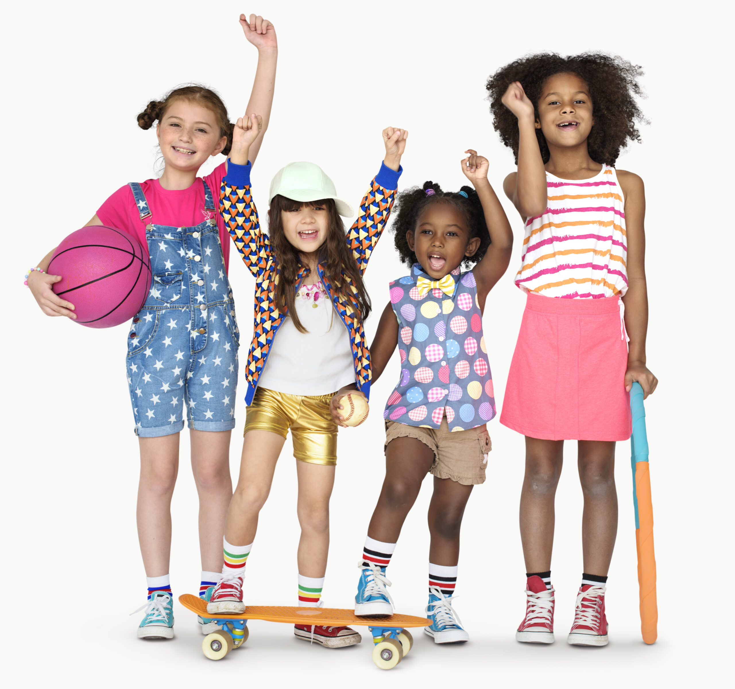 Smiling girls holding sports equipment and skateboards