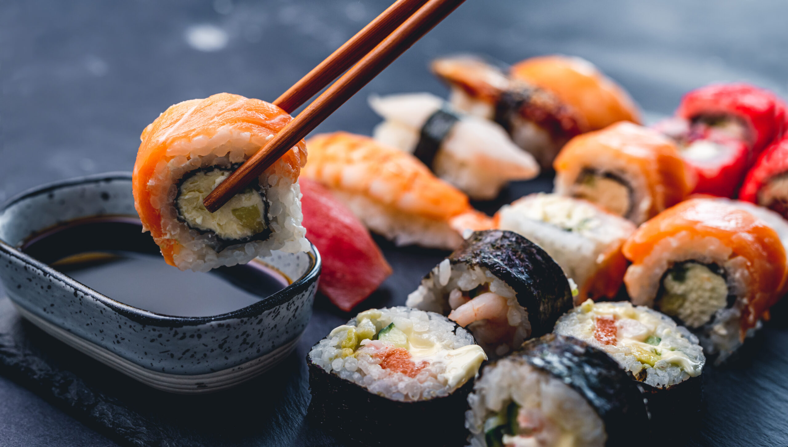 Sushi rolls arranged with soy sauce.
