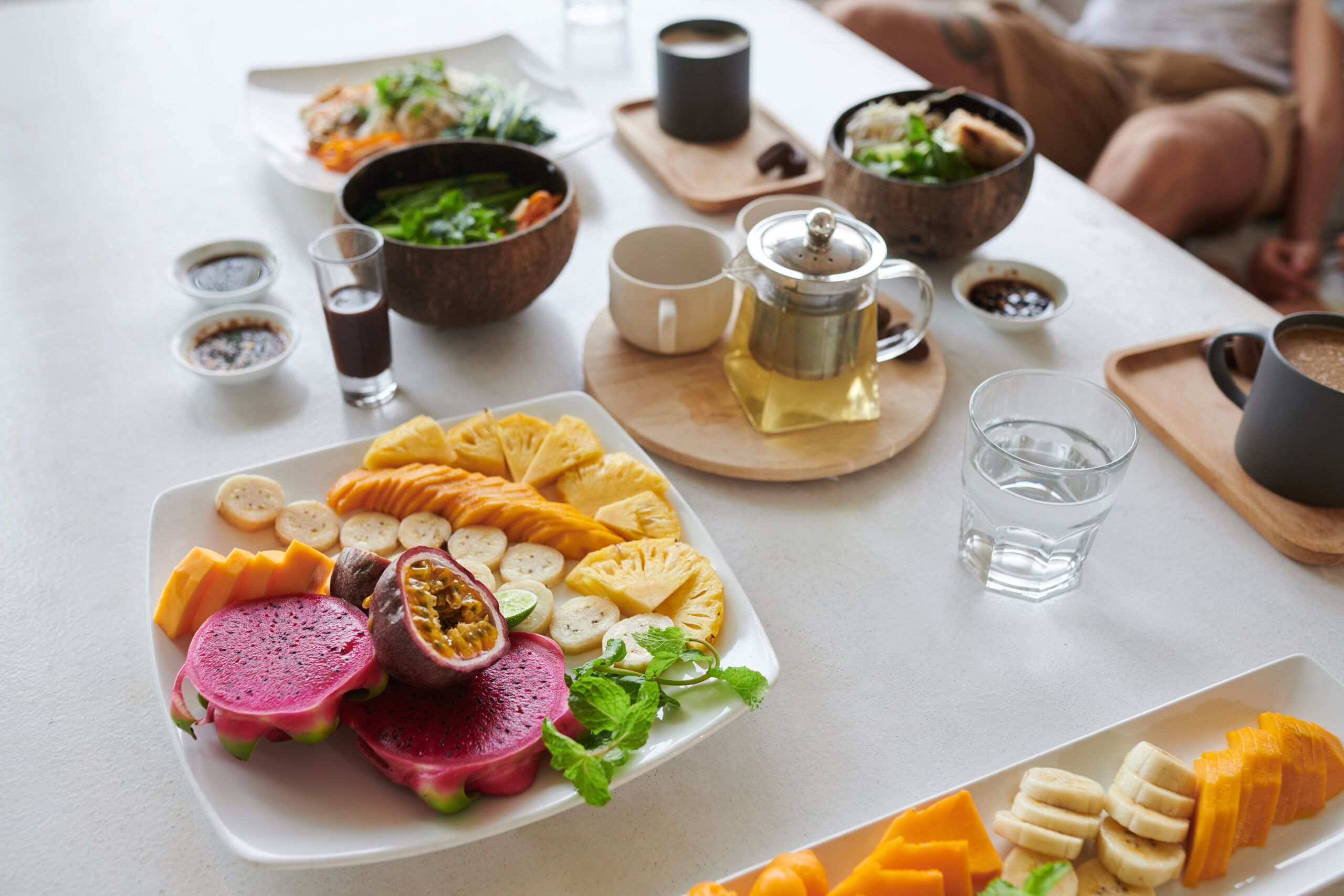 A breakfast table of exotic fruit and salads.