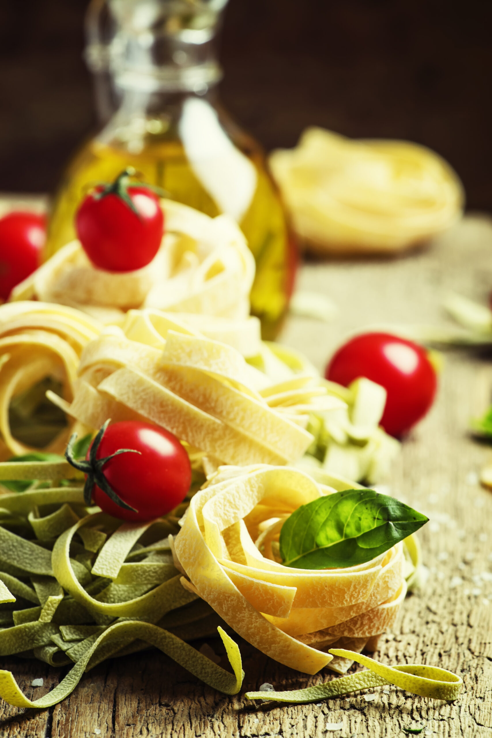 A nest of fresh pasta with tomato and basil.