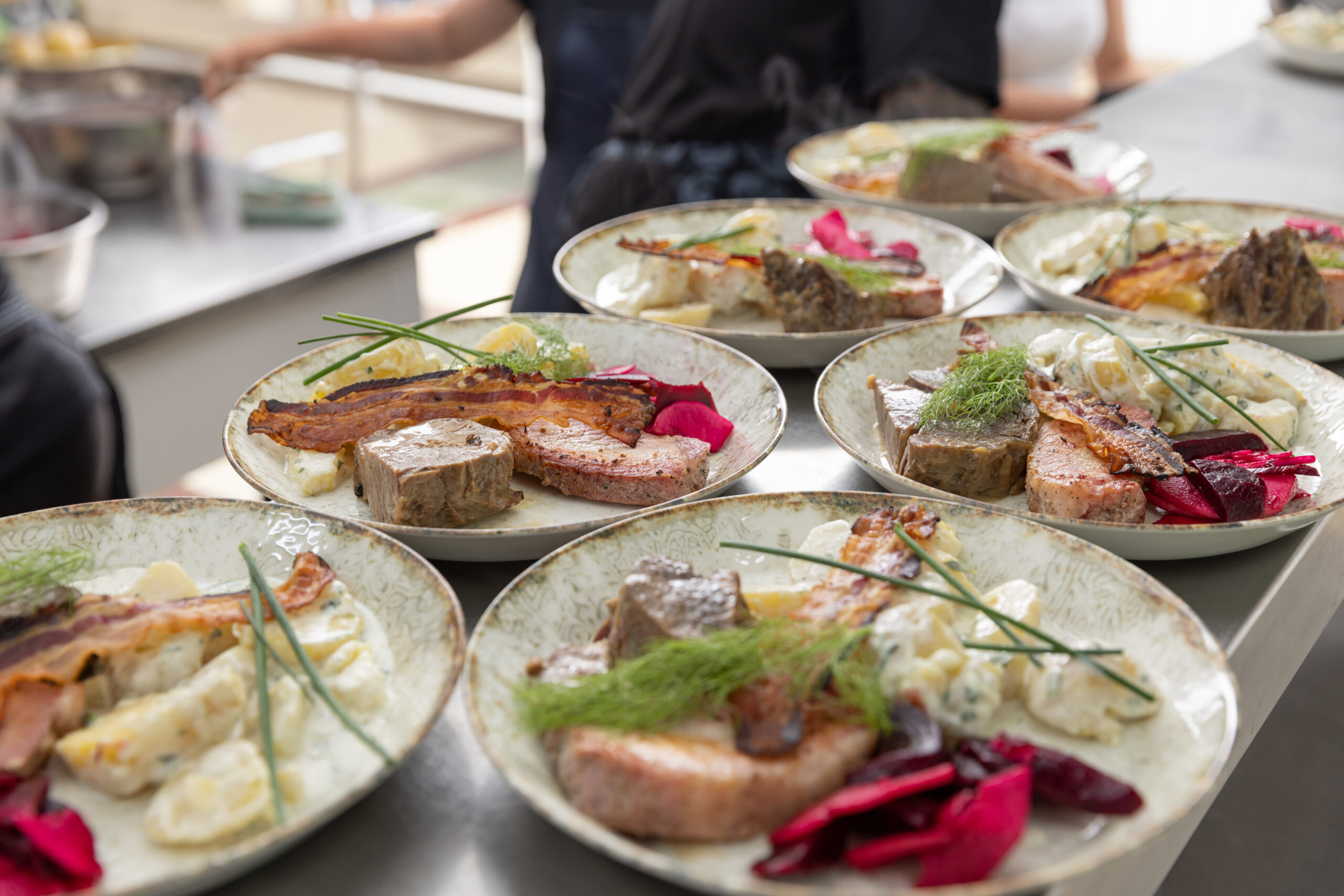 Several plates of prepared food ready to be served.