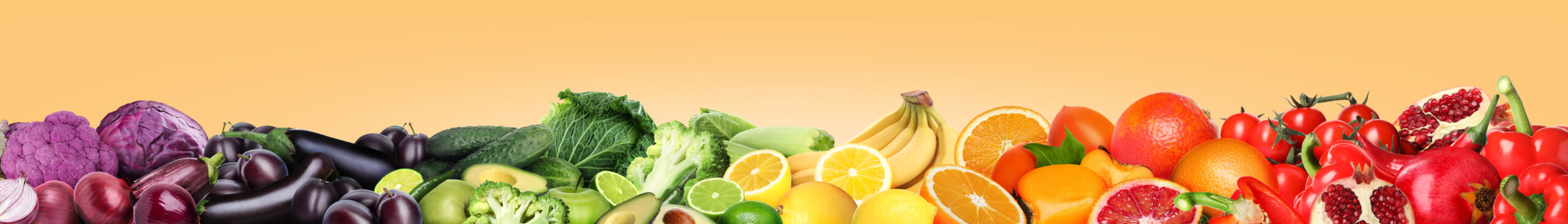 Fruits and vegetables in rainbow order against an orange background.