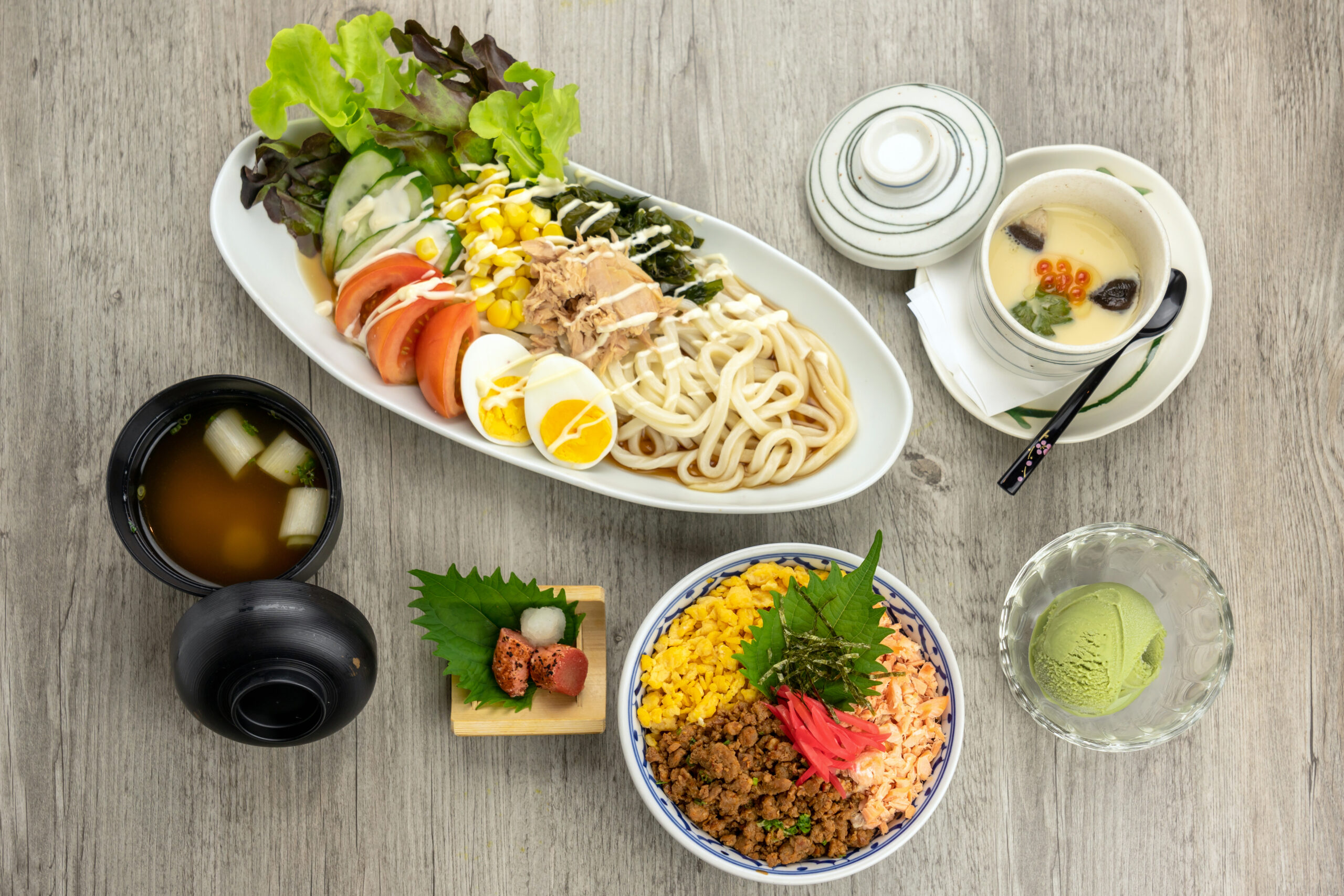 A Japanese meal set with fried rice and udon, seen from above.