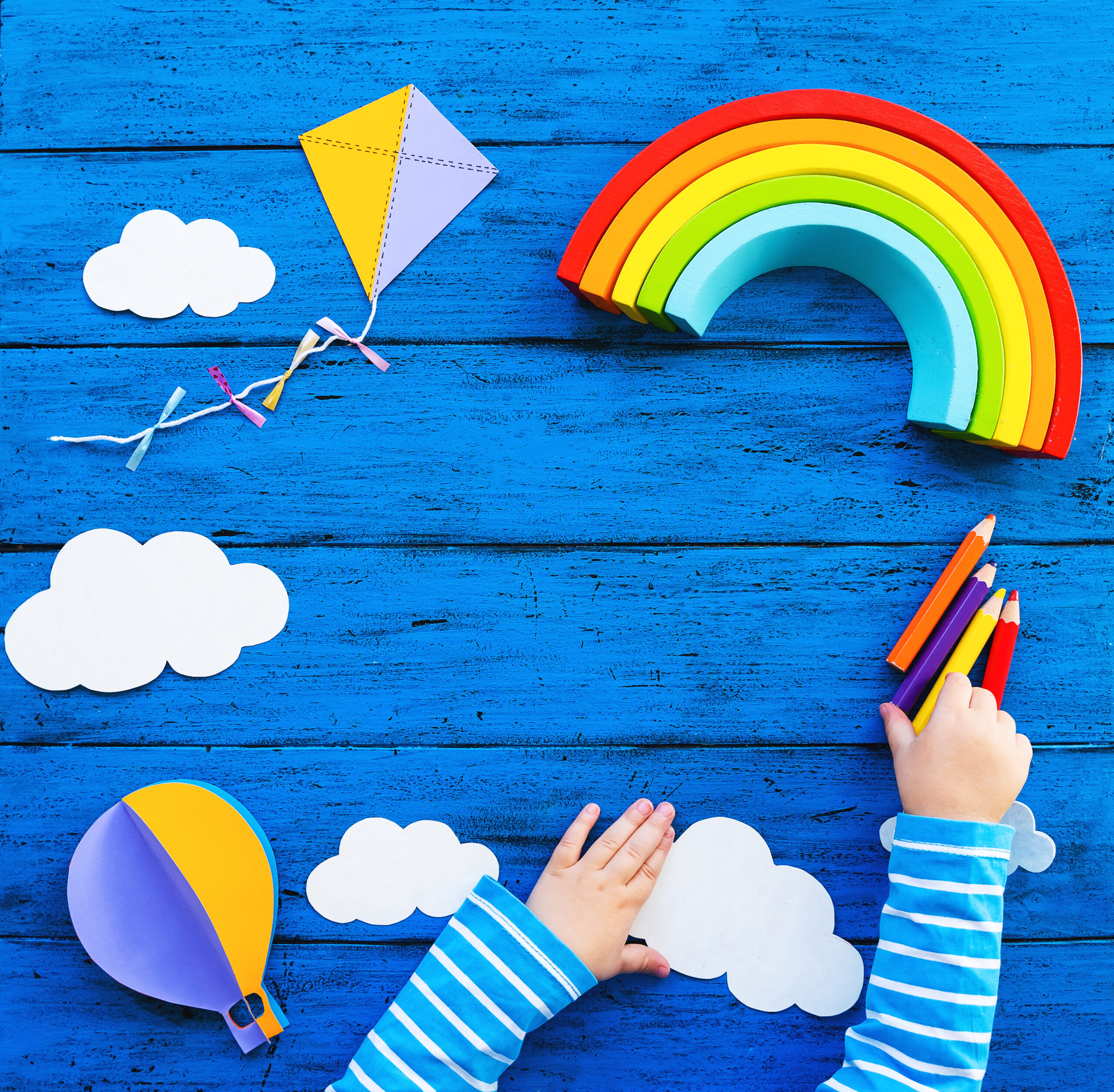 A child&rsquo;s art project on a blue wooden table