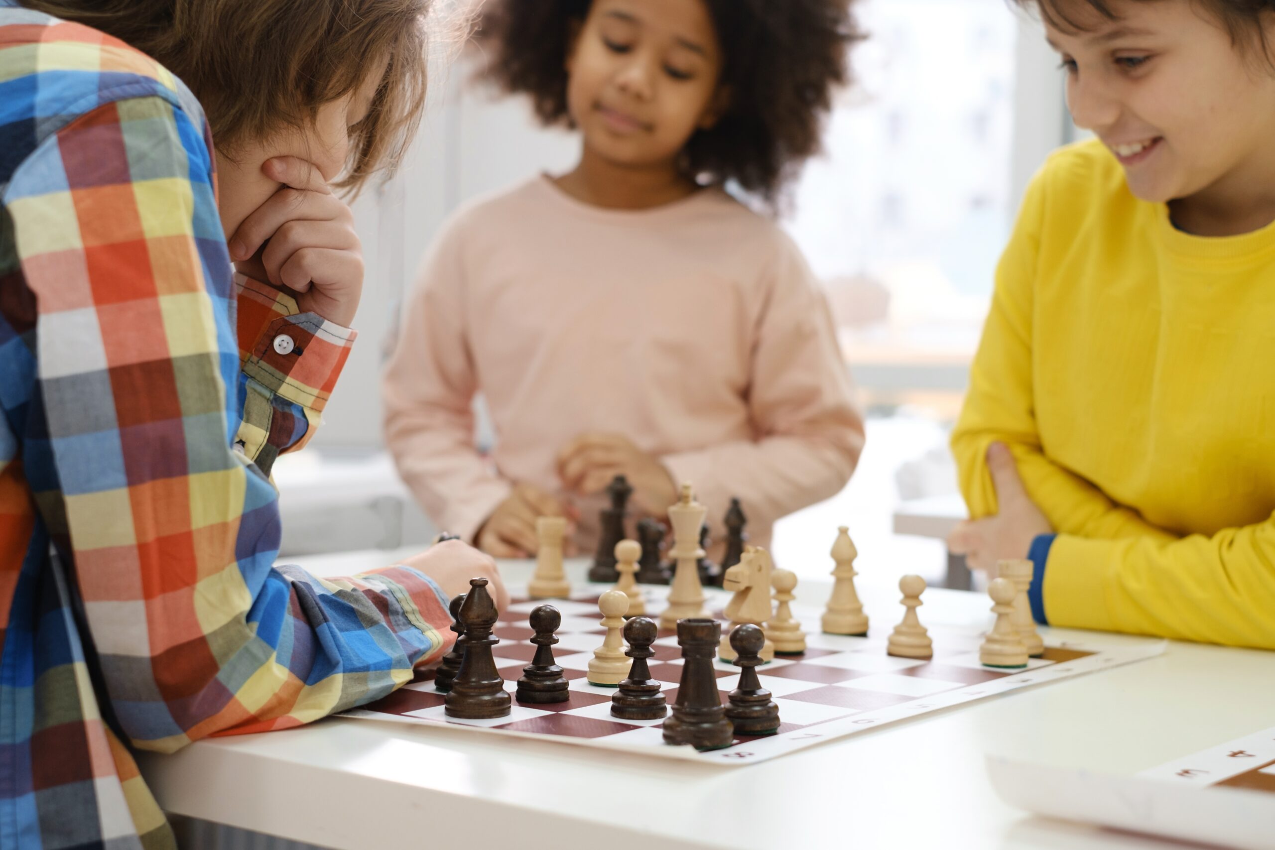 Two children playing chess together