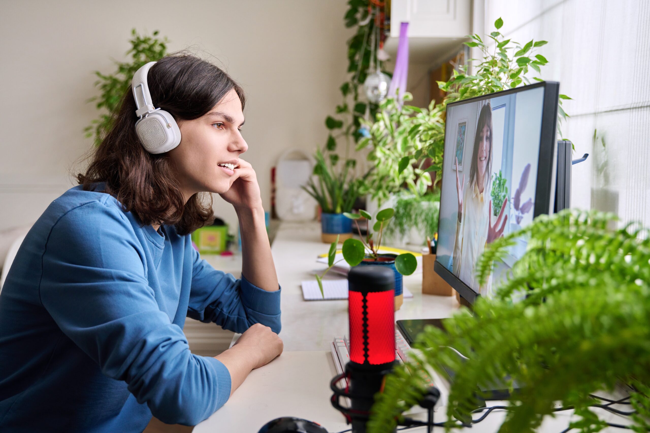 A teenager meeting with a counselor by video from home