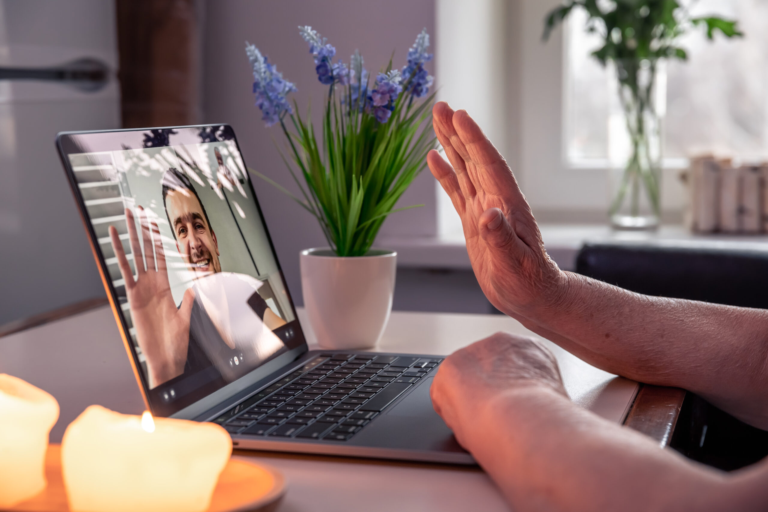 A younger and older person connecting by video call
