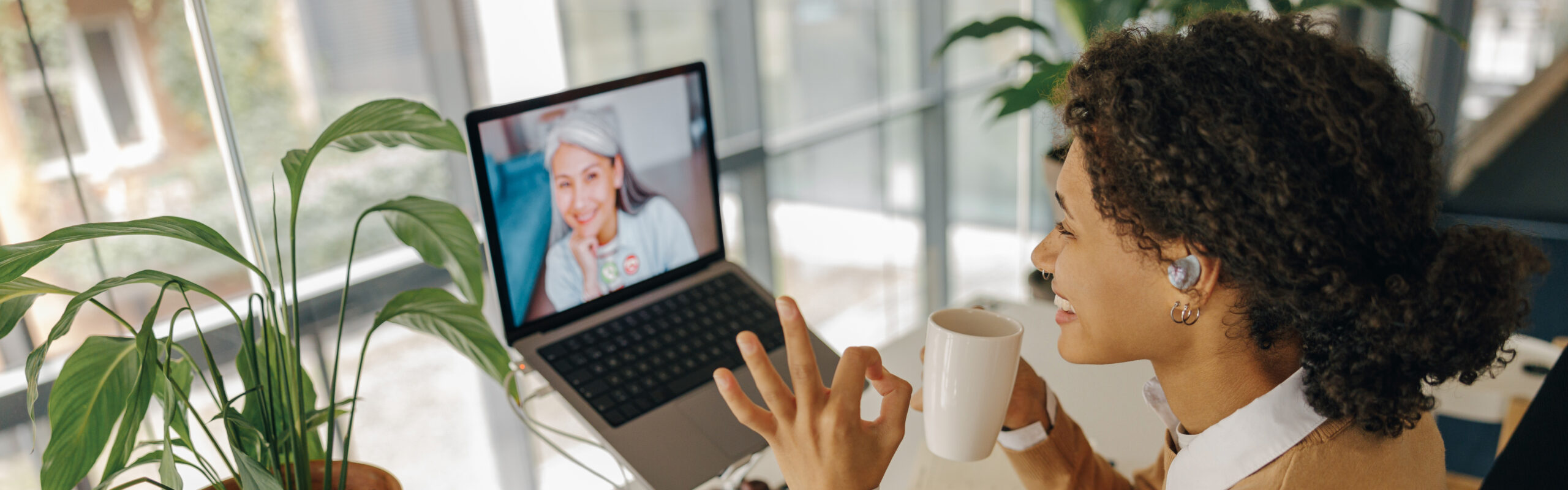 A woman meeting with her counselor by video from home